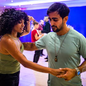 Couple dancing west coast swing at midland swing open