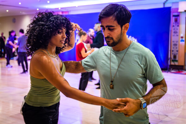 Couple dancing west coast swing at midland swing open