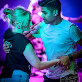 Couple dancing west coast swing at midland swing open